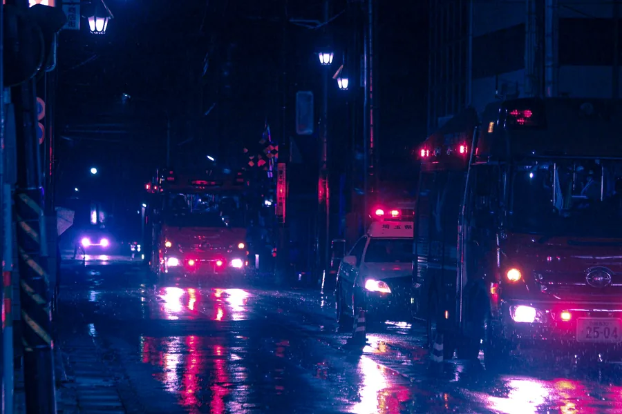 Emergency lights on a wet night street, the moment that follows a person online
